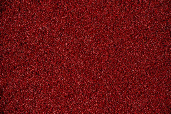 Kum ve çakıl taşlarının yakın plan görüntüleri. Kırmızı çakıl taşları ve kum taneleri. Renkli kum yüksek çözünürlüklü tasarım için, görünür doku için. Üst görünüm kapat