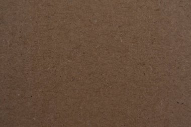 Tasarım arka planı için kahverengi karton kağıt üzerinde tahıl detaylarını, arka plan lekesi ve doku kahverengi kağıt yüzey yüzeyiyle birlikte gösteren kahverengi renkli kağıt.