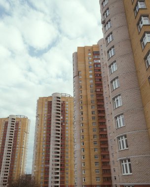 Gün batımında şehir merkezinde, parlak sarı güneş altında güzel yüksek binalar. 