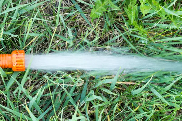 Water flowing from irrigation pipe — Stock Photo, Image