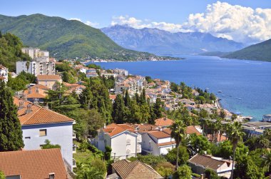 Panoramic views of the bay surrounded by mountains and houses with orange tiled
