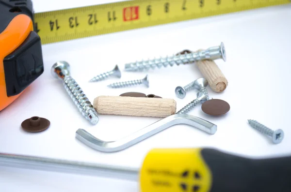 screws, tape measure and a screwdriver ready-to-assemble furnitu