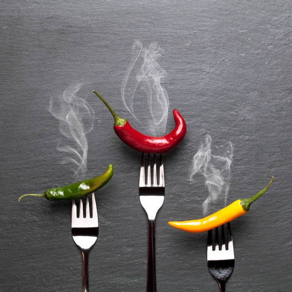 Steaming colorful chili peppers — Stock Photo, Image