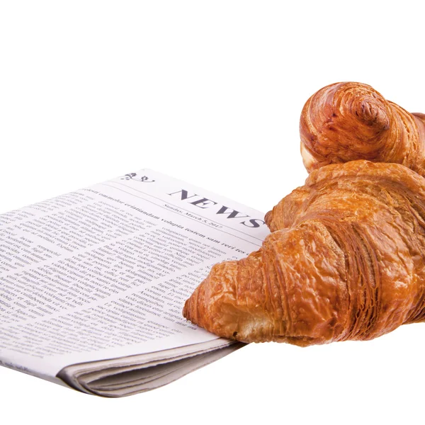 Croissant con un giornale — Foto Stock