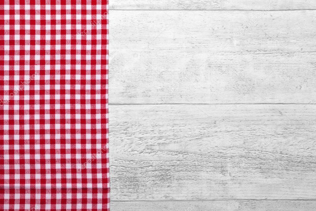 red checkered tablecloth with a wooden background