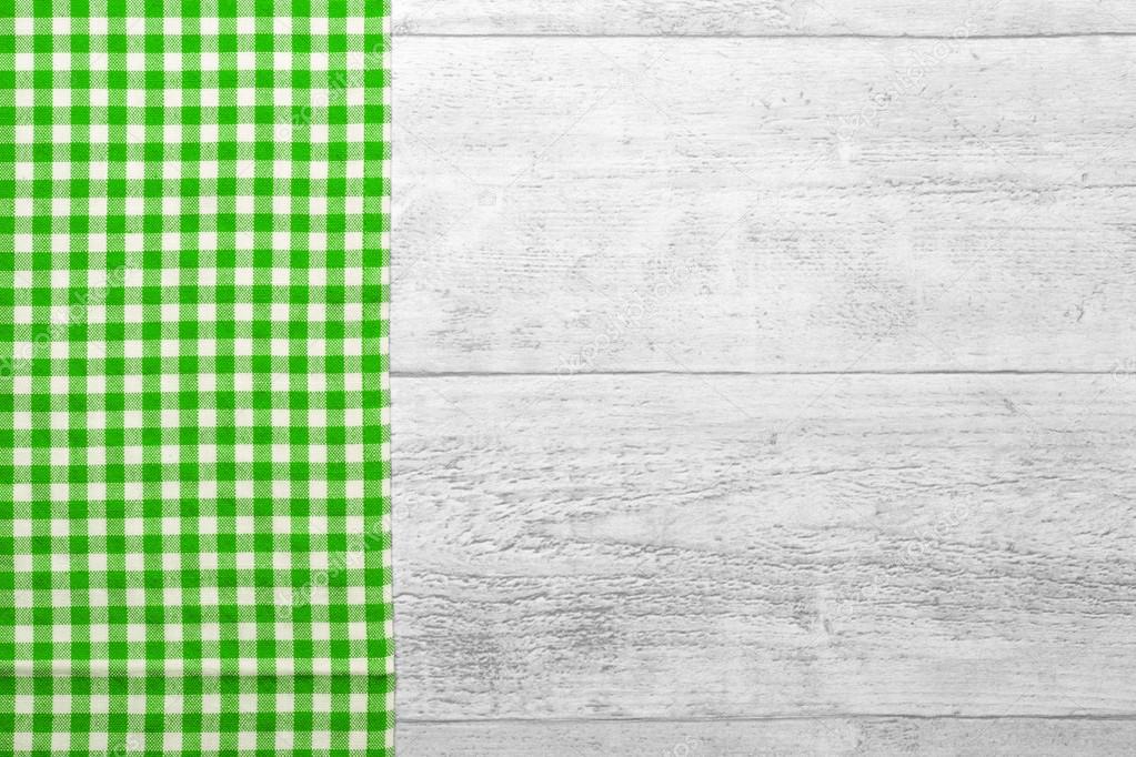 green checkered tablecloth with a wooden background