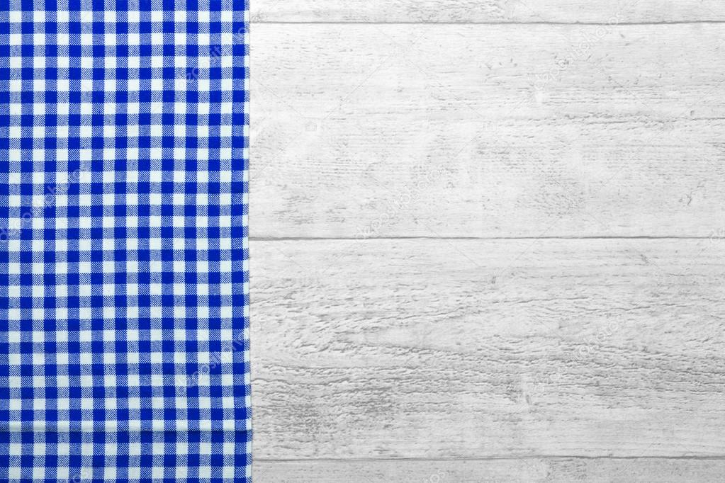 blue checkered tablecloth with a wooden background