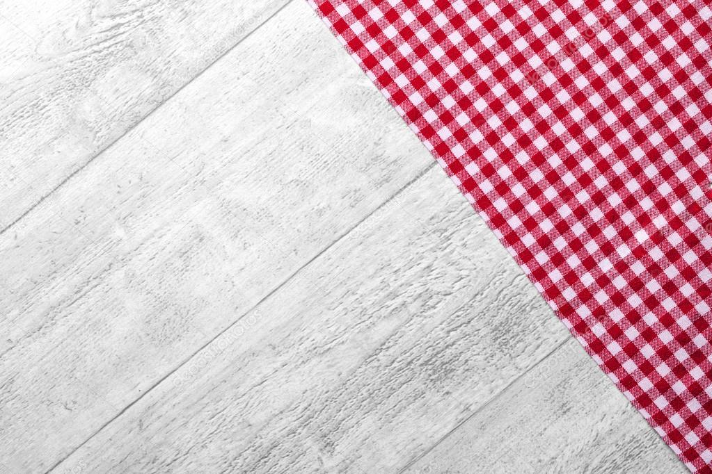 red checkered tablecloth with a wooden background