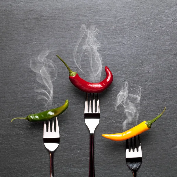 Colorful steaming chili peppers — Stock Photo, Image
