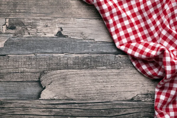 Red checkered tablecloth with rustical wood — Stock Photo, Image