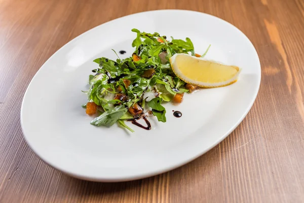 Salad with arugula on white plate — Stock Photo, Image