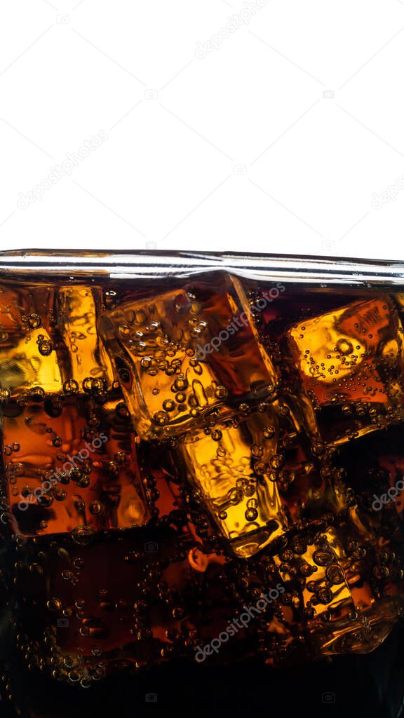 Cola with ice and bubbles in the glass. close up Soft Drink background