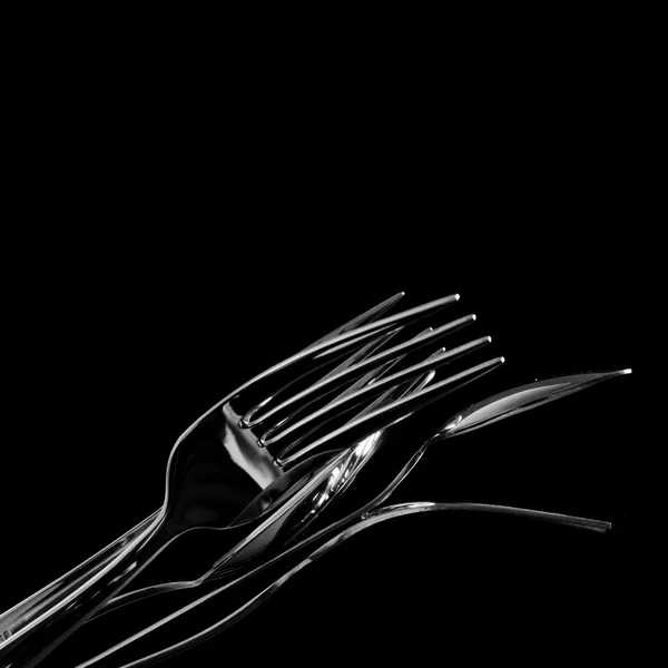 Abstract shapes with flatware on black background — Stock Photo, Image