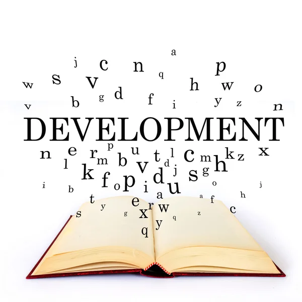 Development, word on the book with letters flying — Stock Photo, Image