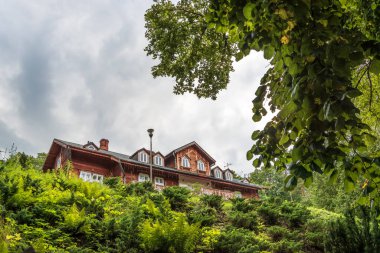 Polonya 'nın Zwierzyniec kentindeki Roztocze Ulusal Parkı' nın genel merkezi. 1890 'dan kalma tarihi konutlar aşağıdan görülmüş. Ön planda ağaçlar ve çalılar.