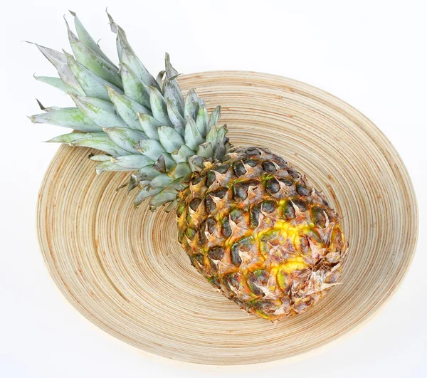 Fresh pineapple on wooden plate — Stock Photo, Image