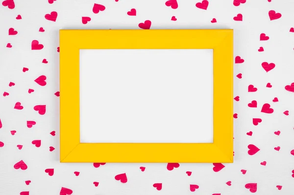 Yellow frame on red hearts background with copy space. Minimal Valentines day concept.