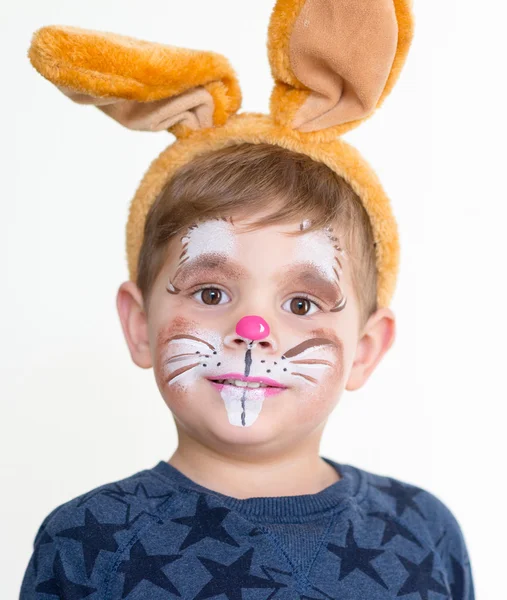 Хлопчик дитина обличчям пофарбований великодній кролик Ліцензійні Стокові Зображення