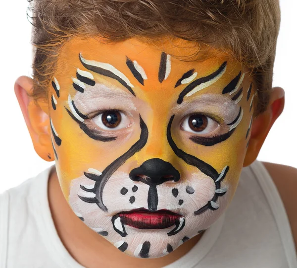 Lovely adorable kid with paintings on his face as a tiger or lion Stock Image