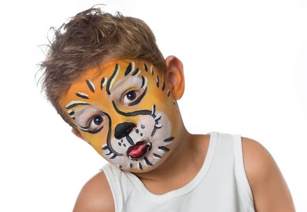 Lovely adorable kid with paintings on his face as a tiger or lion Stock Image