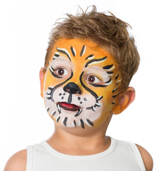 Lovely adorable kid with paintings on his face as a tiger or lion Stock Image