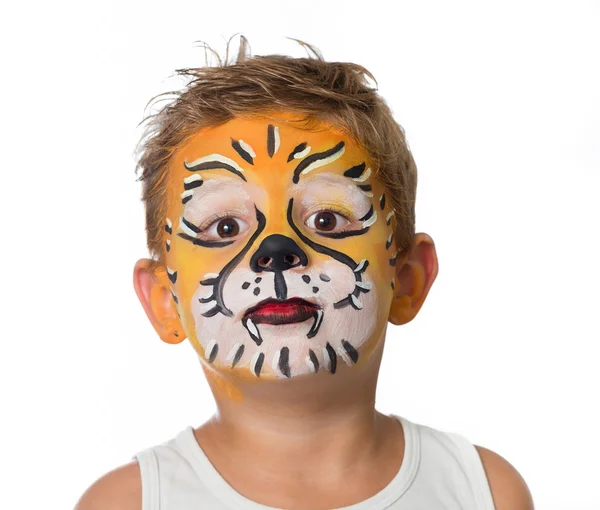 Lovely adorable kid with paintings on his face as a tiger or lion Stock Image