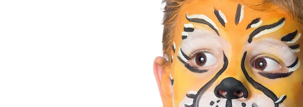 Lovely adorable kid with paintings on his face as a tiger or lion Stock Photo