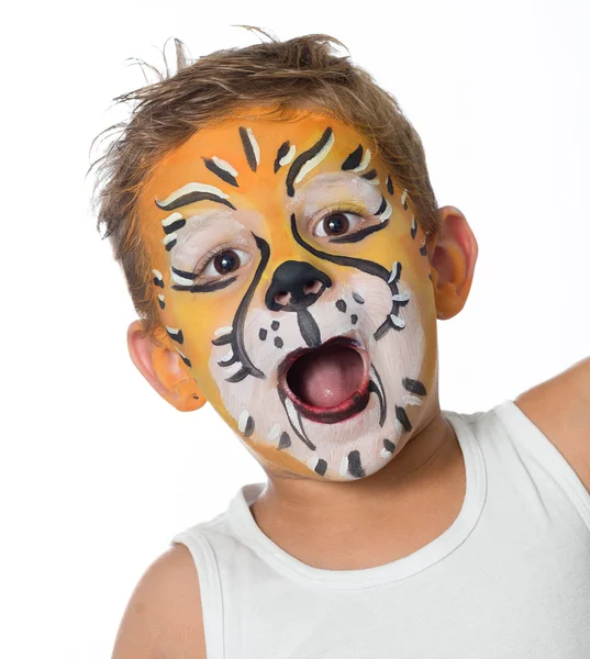 Lovely adorable kid with paintings on his face as a tiger or lion Stock Picture