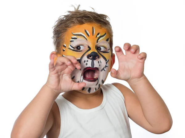 Lovely adorable kid with paintings on his face as a tiger or lion Stock Image