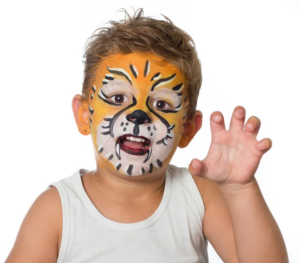 Lovely adorable kid with paintings on his face as a tiger or lion Royalty Free Stock Images