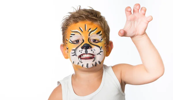 Lovely adorable kid with paintings on his face as a tiger or lion Royalty Free Stock Photos