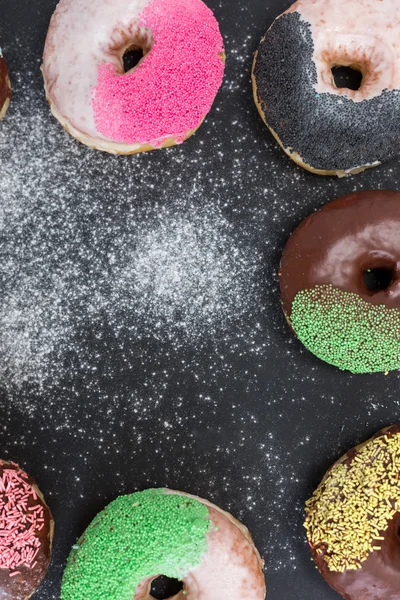 Colorful donuts on stone table. Top view with copy space — Stock Photo, Image