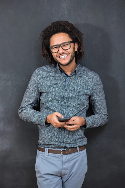 Typing message. Handsome young man with afro hair in shirt holdi — Stock Photo, Image