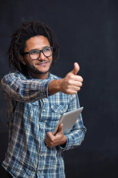 Genieten van zijn digitale Tablet PC. Vrolijke jonge Afrikaanse man houden — Stockfoto