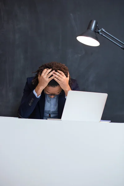 Portrait of smart businessman busy working at desk, using mobile