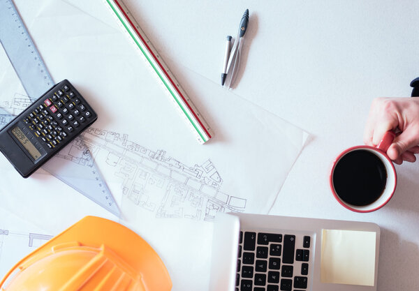 Architect working on blueprint. Architects workplace - architect