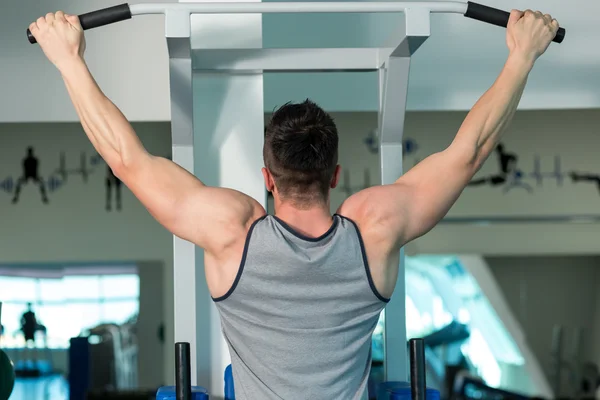 Young male bodybuilder doing heavy weight exercise Stock Photo