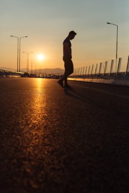 Büyük modern Köprüsü'nde sunse boyunca hızlı koşan çekici uygun adam