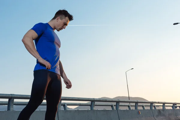 Portrait of male runner taking break after run while standing on — Stock Photo, Image