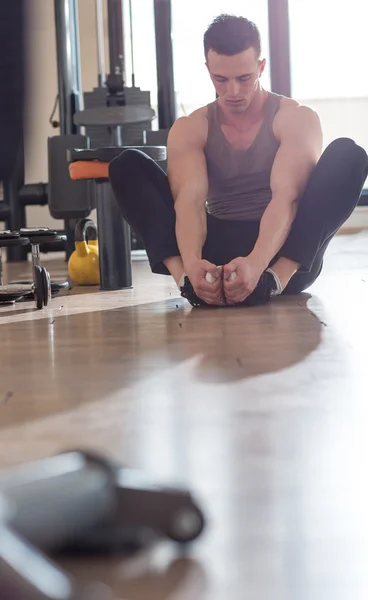 Hombre musculoso guapo haciendo ejercicio de estiramiento. — Foto de Stock