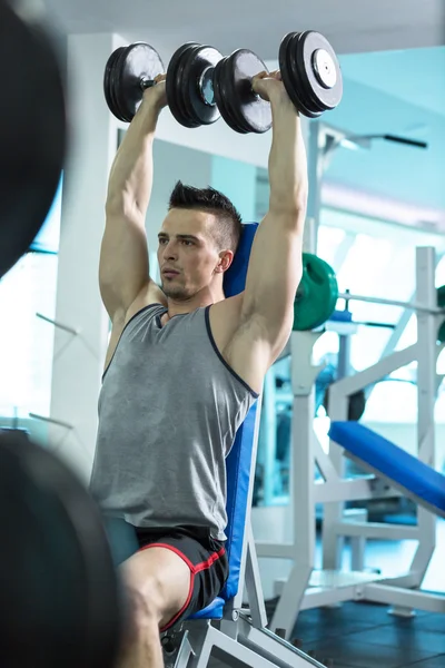 Jovem muscular fazendo exercício de peso pesado para bíceps com D — Fotografia de Stock