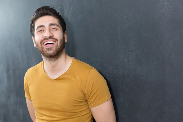 Smiling casual man close up portrait against dark background. — Stock Photo, Image