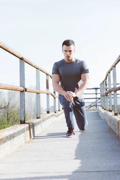 Tired after jogging. Concentrated young man resting after runnin — Stock Photo, Image