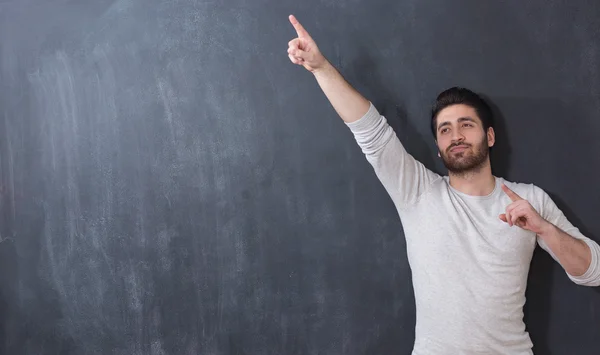 Handsome man with beard showing something on chalkboard, copy sp — Stock Photo, Image