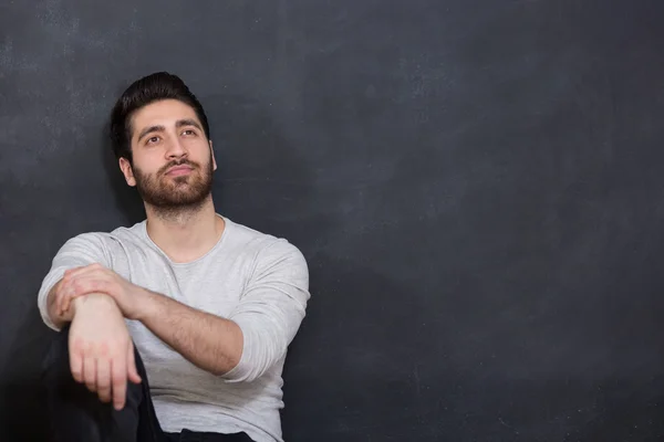 Handsome man with beard showing something on chalkboard, copy sp — Stock Photo, Image
