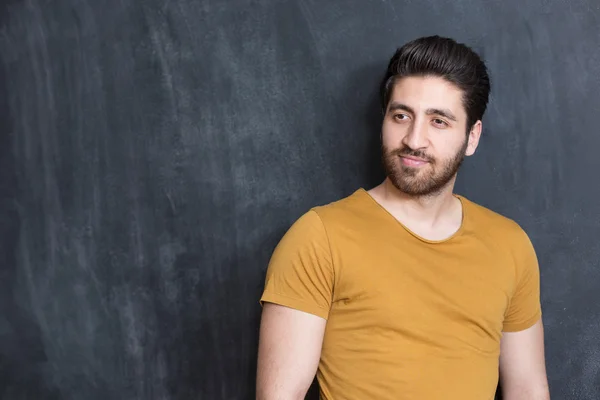 Portrait of a fashionable young man on dark background, chalkboa — Stock Photo, Image