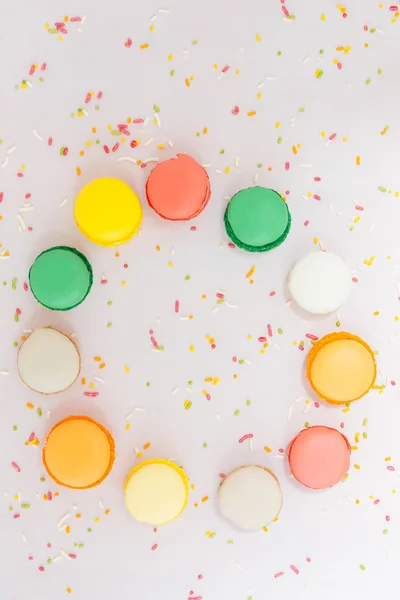 Galletas macarrones franceses de colores dulces sobre fondo pastel, a — Foto de Stock