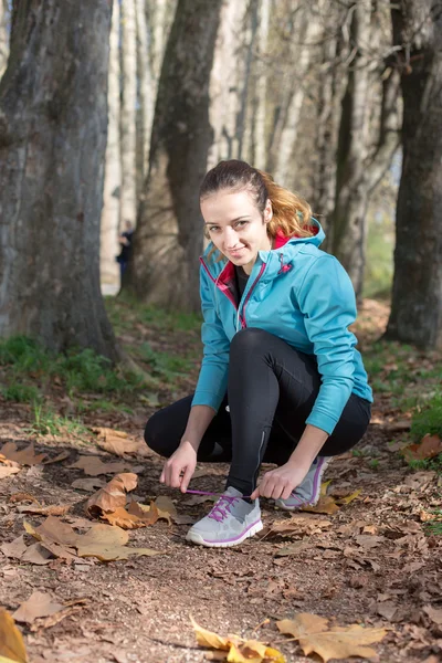 Healthy fitness woman resting in woods after a trail run. vitali — Stock Photo, Image