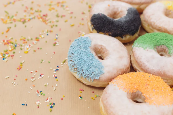 Colorful donuts on  kraft paper — Stock Photo, Image