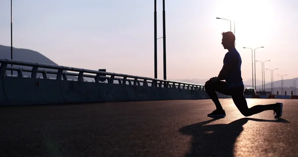 Man stretching at sunset — Stock Photo, Image